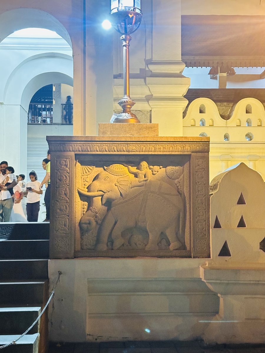 Carved stone elephant panel at a heritage site